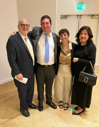 4 people posing together in a lobby.