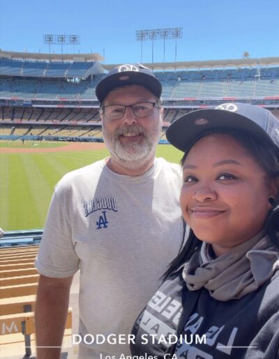 selfie of two dodgers fans in front of baseball field
